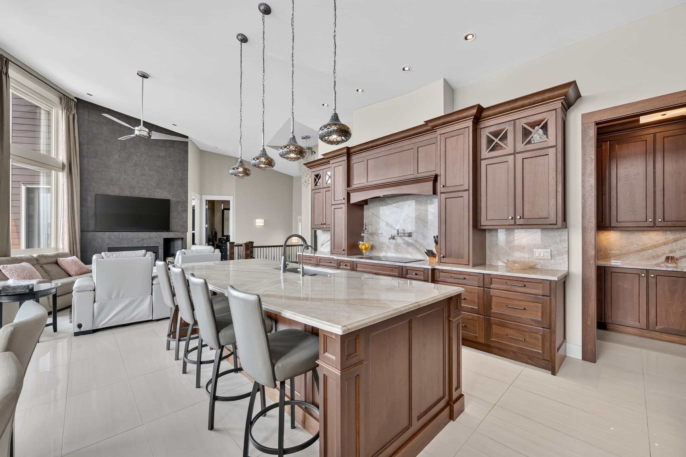 The same kitchen and adjoining living area with balanced midtones, cleaner shadows, and preserved window detail