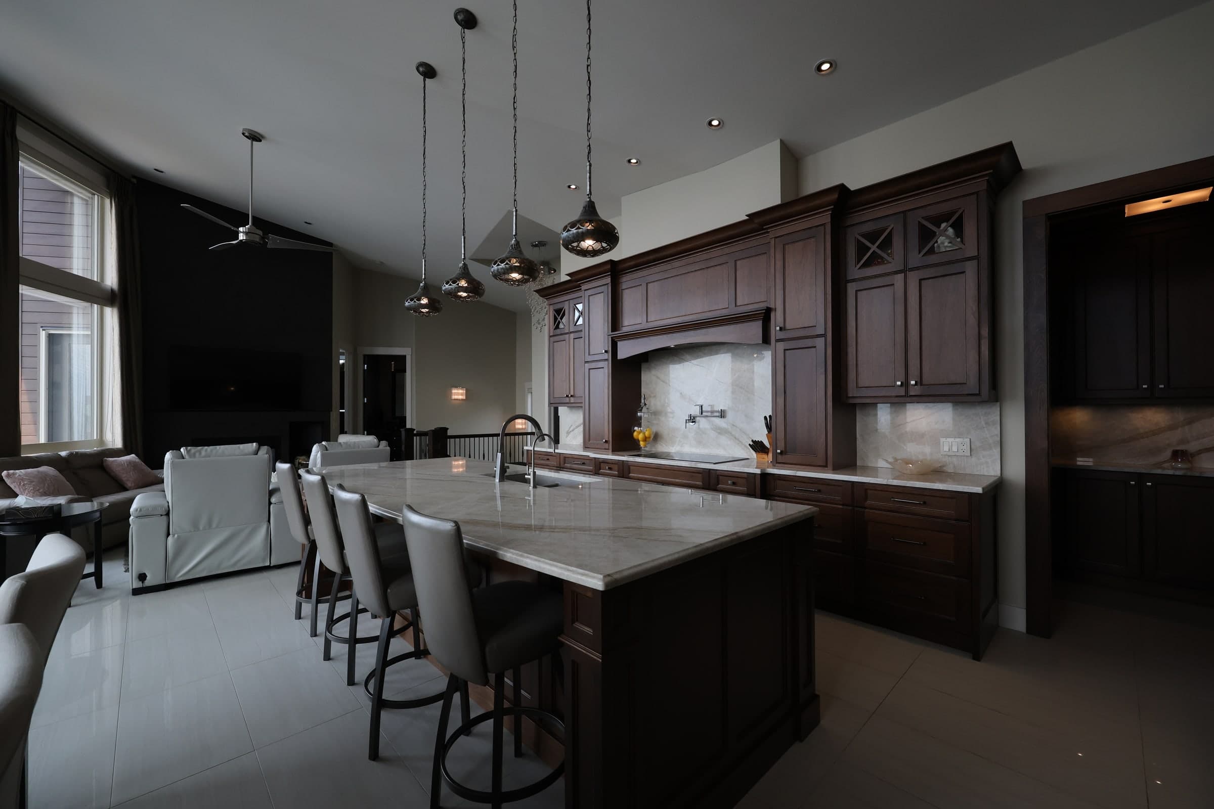 Underexposed kitchen and adjoining living area with dark cabinetry and blocked interior shadows