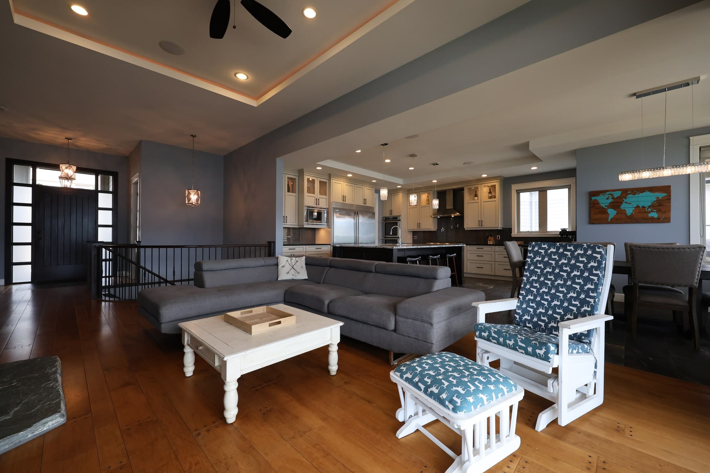 Open-plan living room and kitchen photographed with deep but readable interior shadows