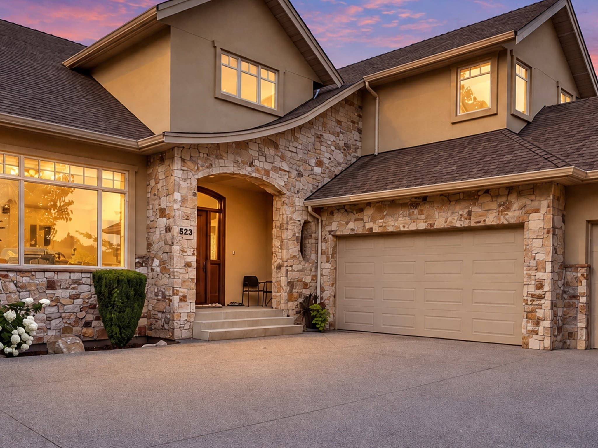 Full-size review crop showing the house roof, stonework, windows, entrance, and garage