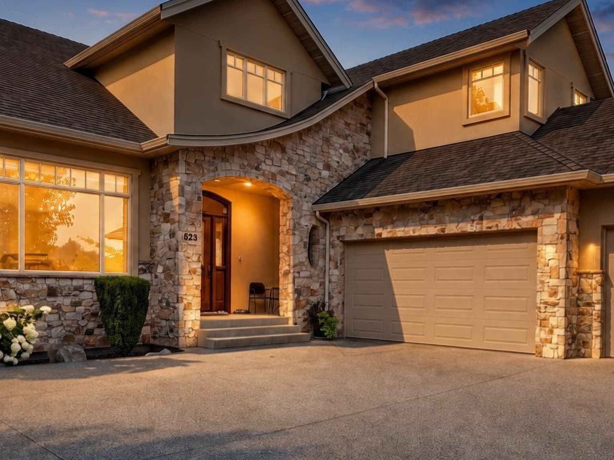 Full-size review crop showing the house roof, stonework, windows, entrance, and garage