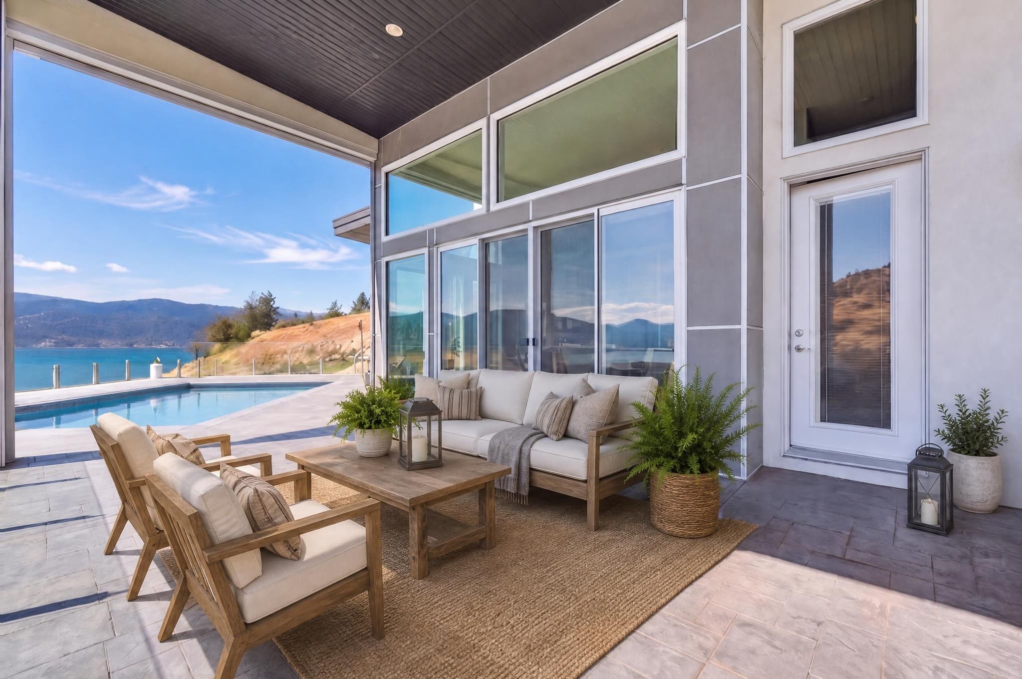 Furnished outdoor patio used to inspect glass reflections, lawn, sky, architecture, and exterior texture