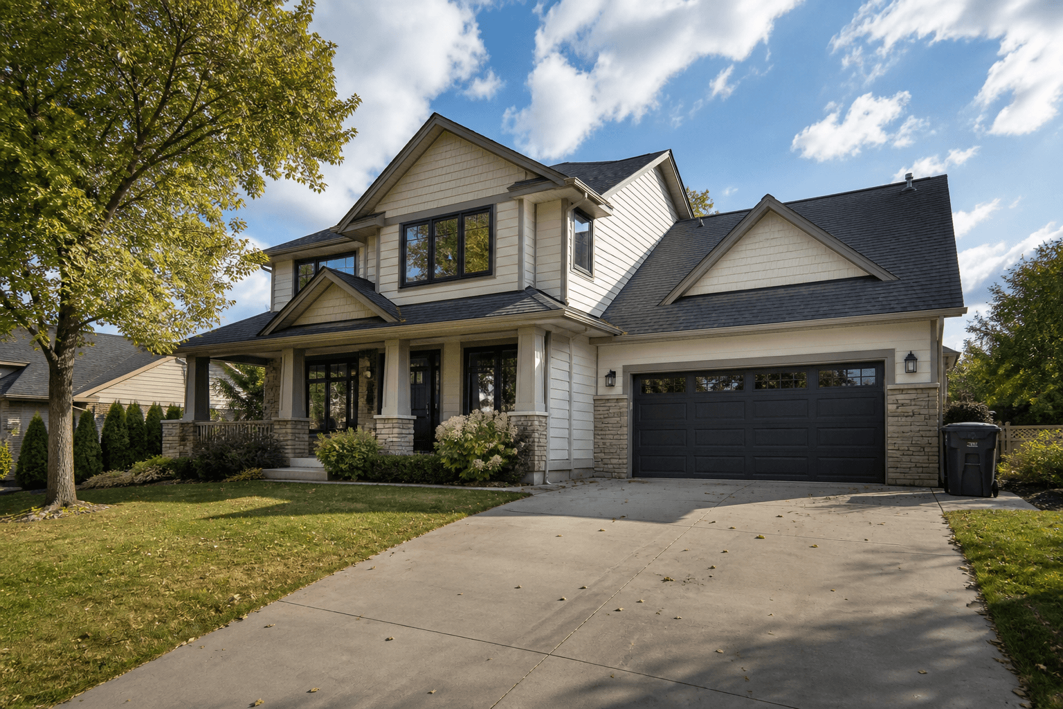 Editorial source exterior with a trash bin, loose driveway leaves and natural seasonal lawn