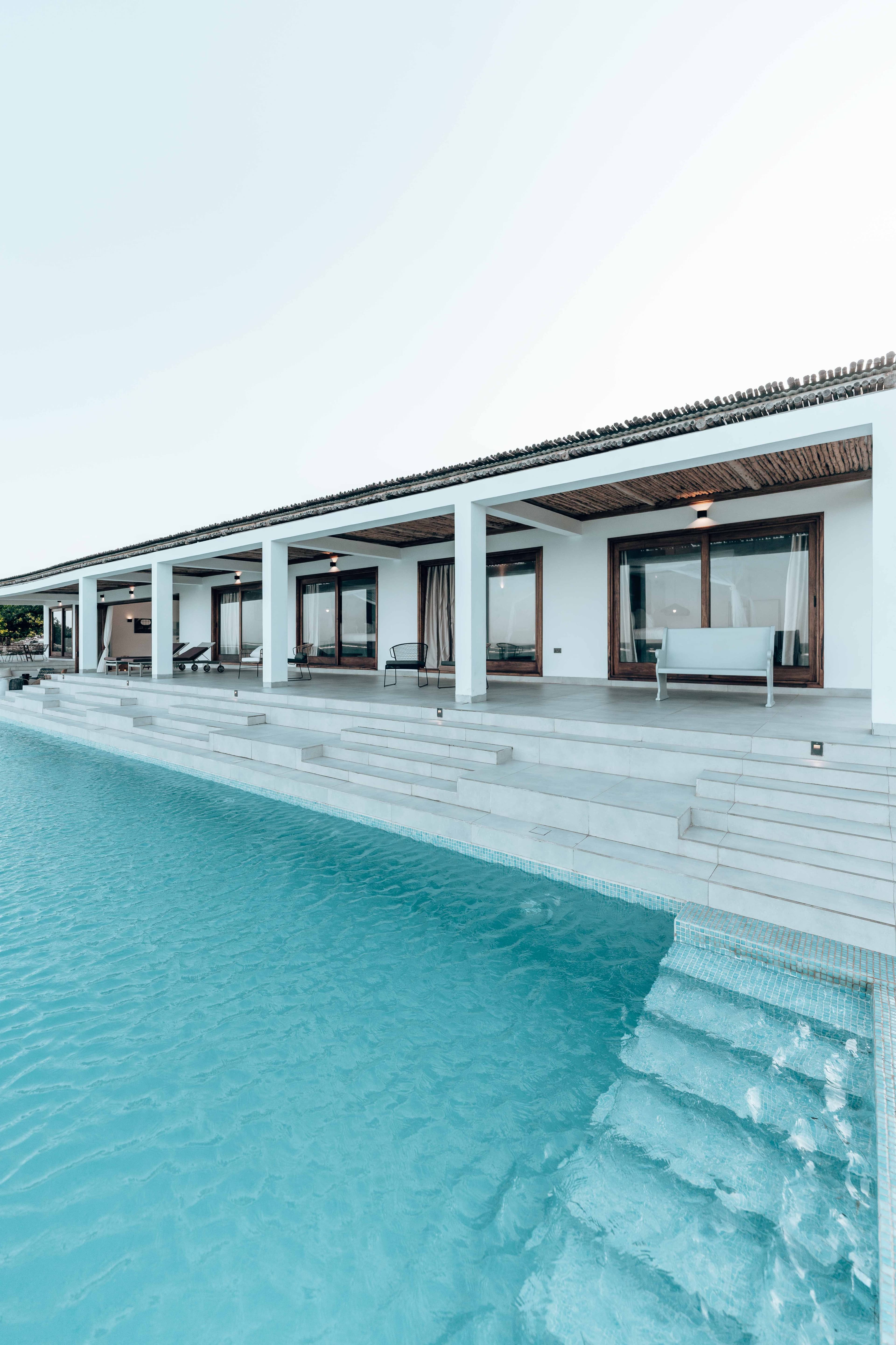 A modern villa and swimming pool photographed in clear daylight